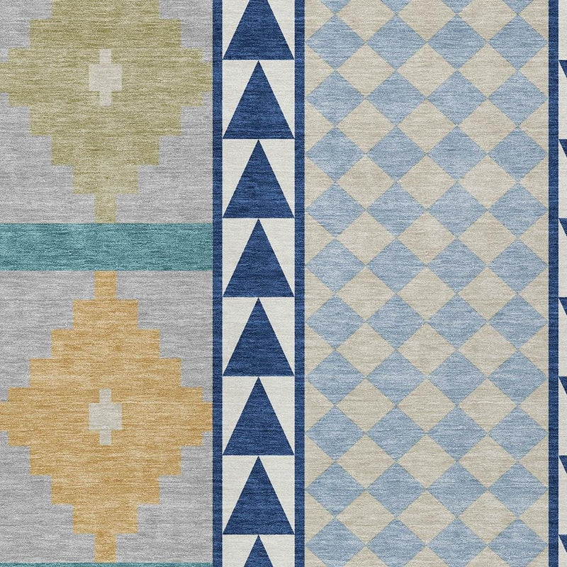 Area rug pattern close-up with tan cross shapes, teal stripe, navy chevrons, and diamonds