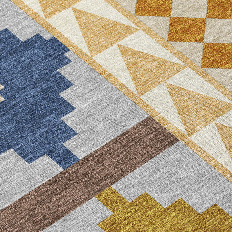 Close-up Southwestern rug texture with gray field, blue cross motif, and mustard diamonds