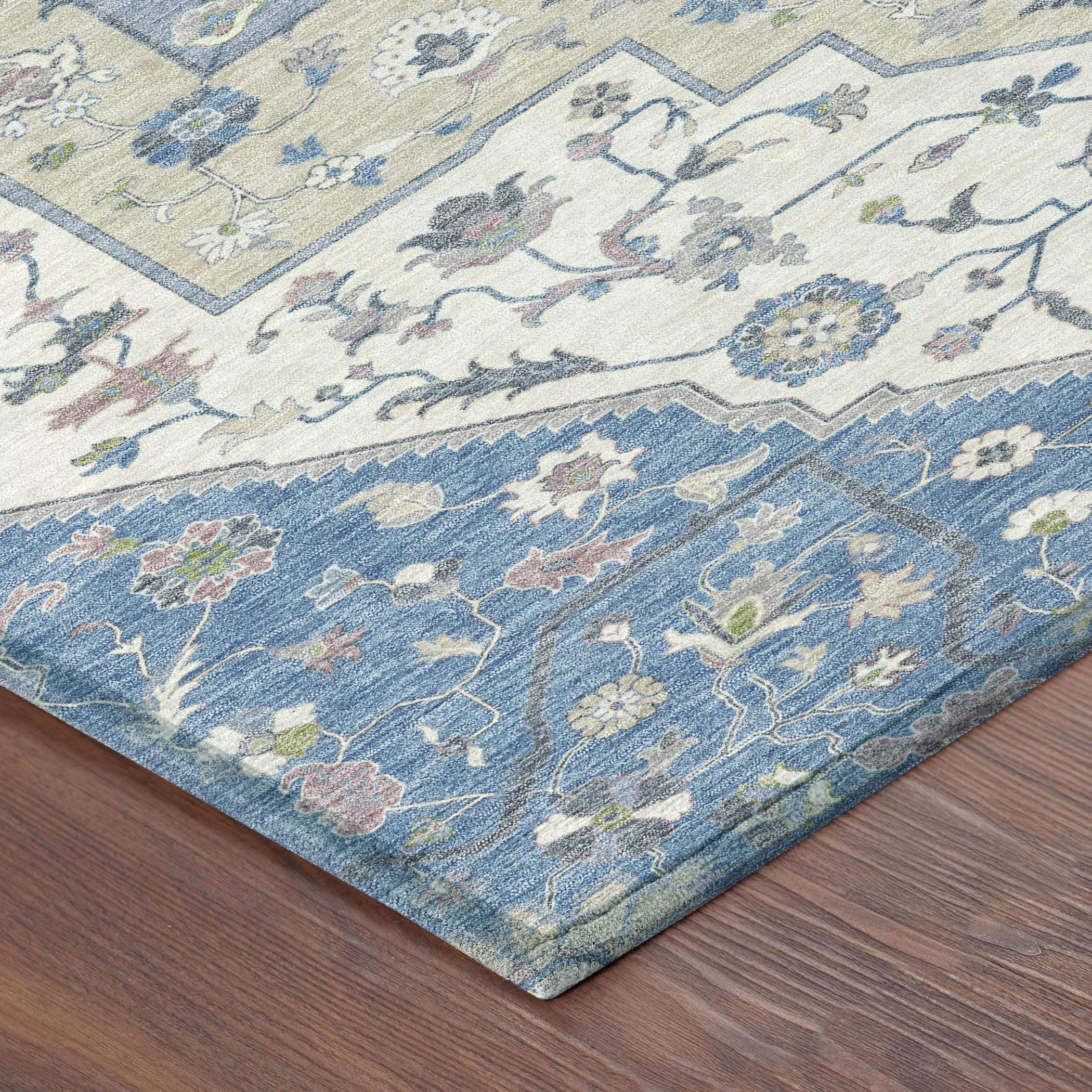 Blue and cream floral area rug, featuring detailed oriental design, soft texture, and intricate pattern on hardwood floor.