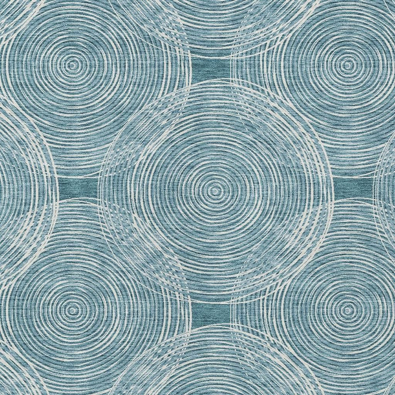 Teal blue area rug close-up with concentric circle pattern and ivory connecting lines