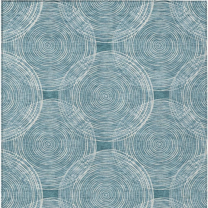 Teal blue and ivory geometric area rug pattern with concentric circles and interlocking arcs