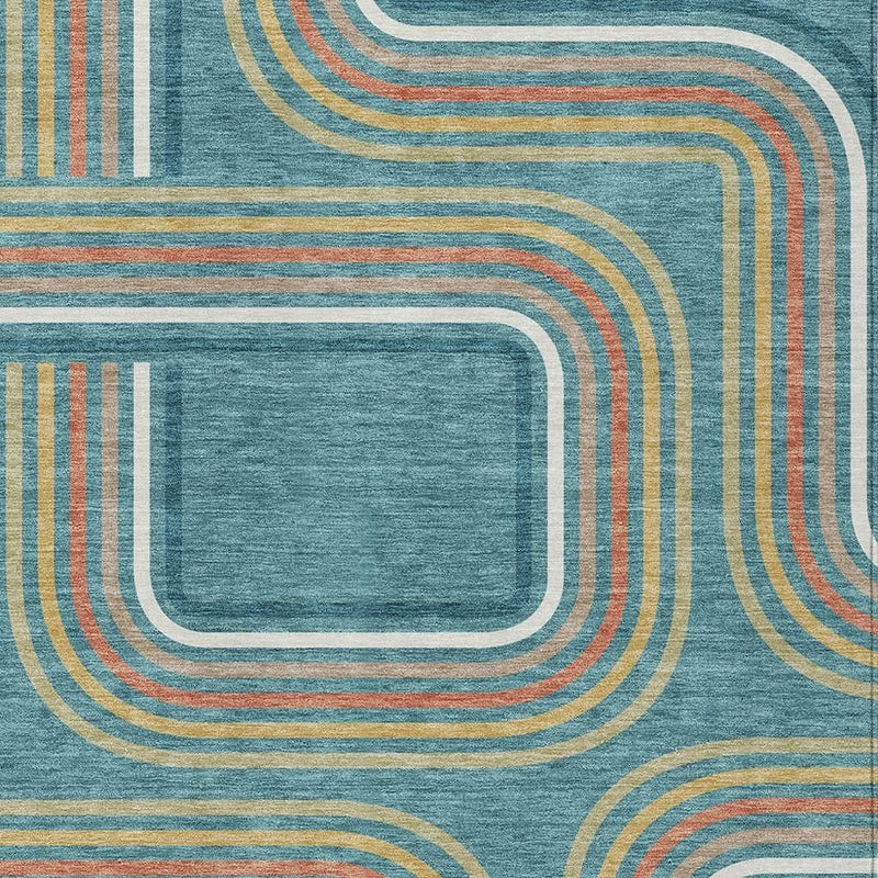 Teal blue geometric area rug close-up with layered wave outlines in ivory and tan