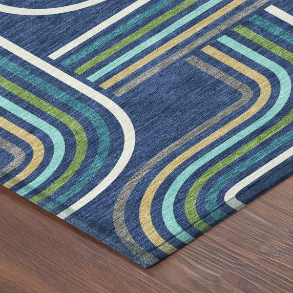 Navy blue geometric area rug with aqua and gold wavy line pattern at corner