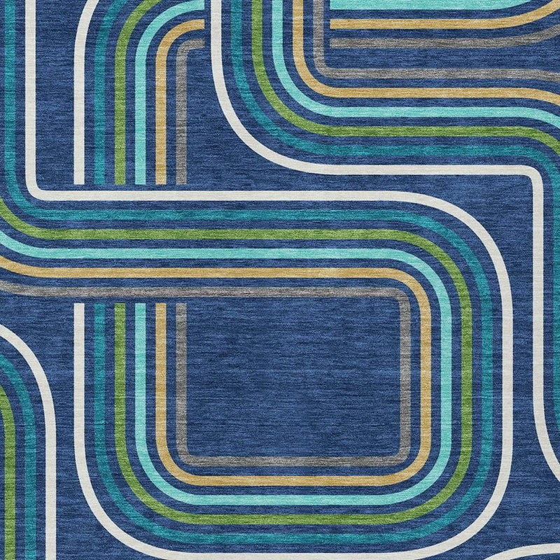 Geometric area rug detail: navy blue with aqua, gold, and white outlined curves