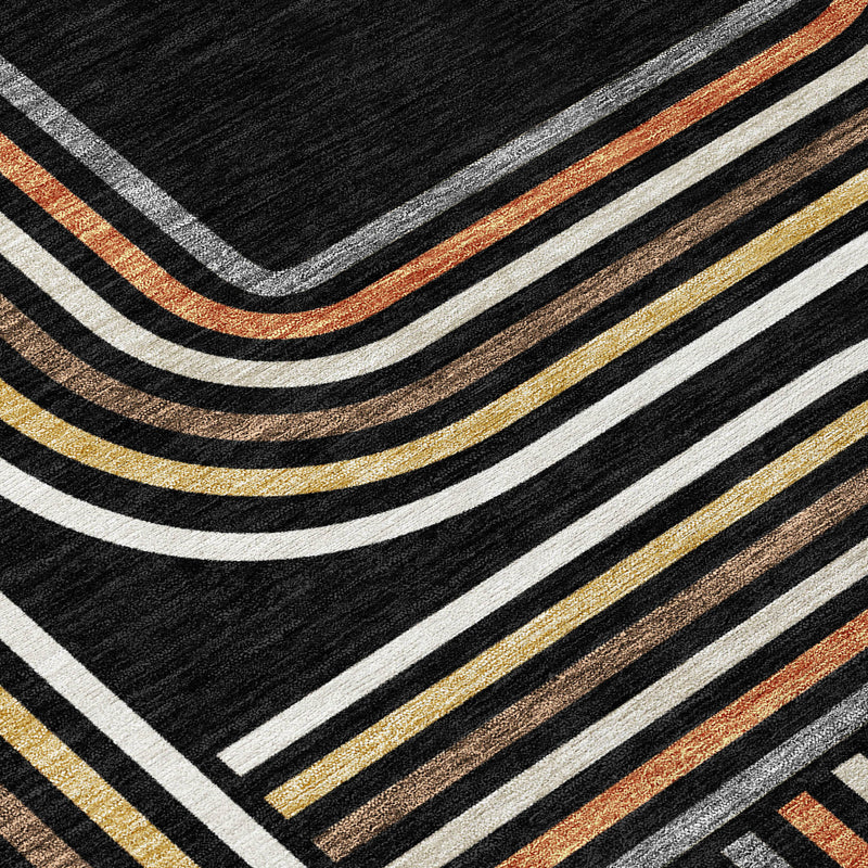 Black geometric area rug with ivory, gold, and orange diagonal line waves