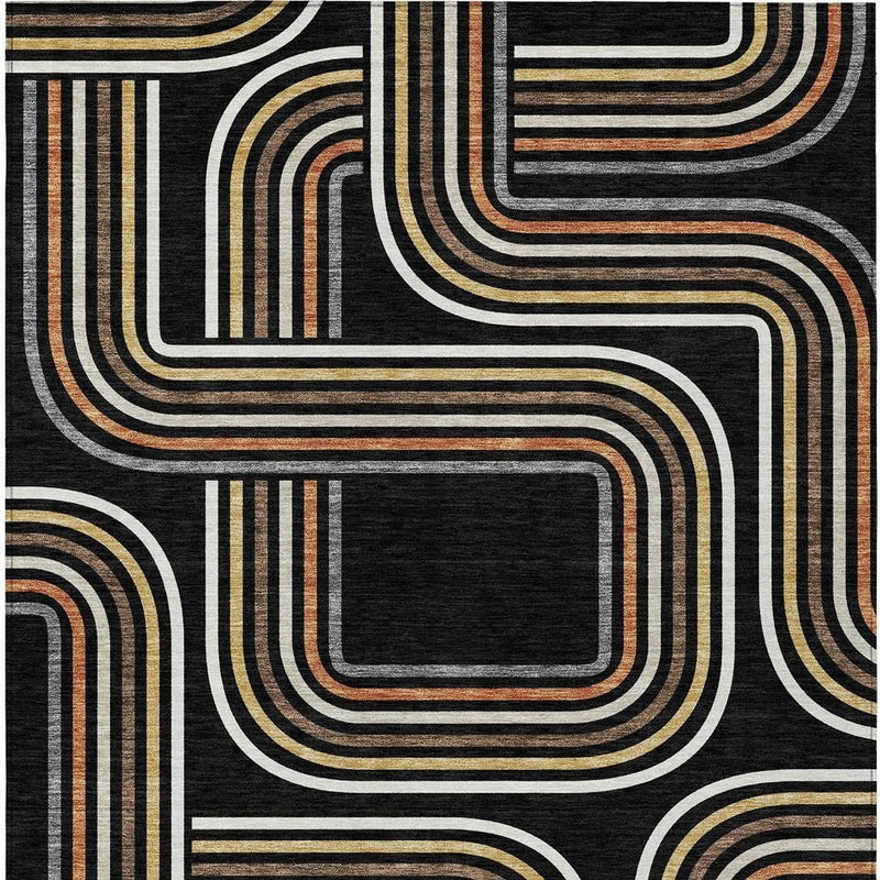Black geometric area rug close-up with ivory, gold, and orange wavy rectangles