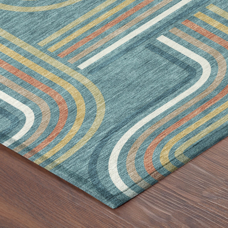 Teal blue geometric area rug corner with curved line pattern and contrasting ivory trim.