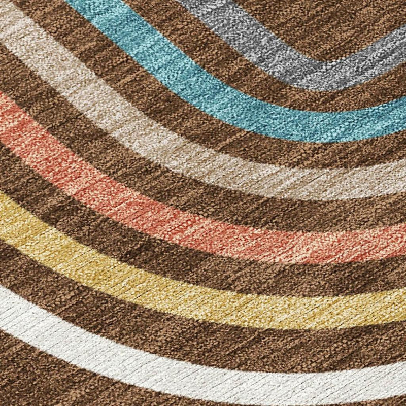 Close-up area rug with curved stripe pattern in brown, ivory, teal, coral, and yellow