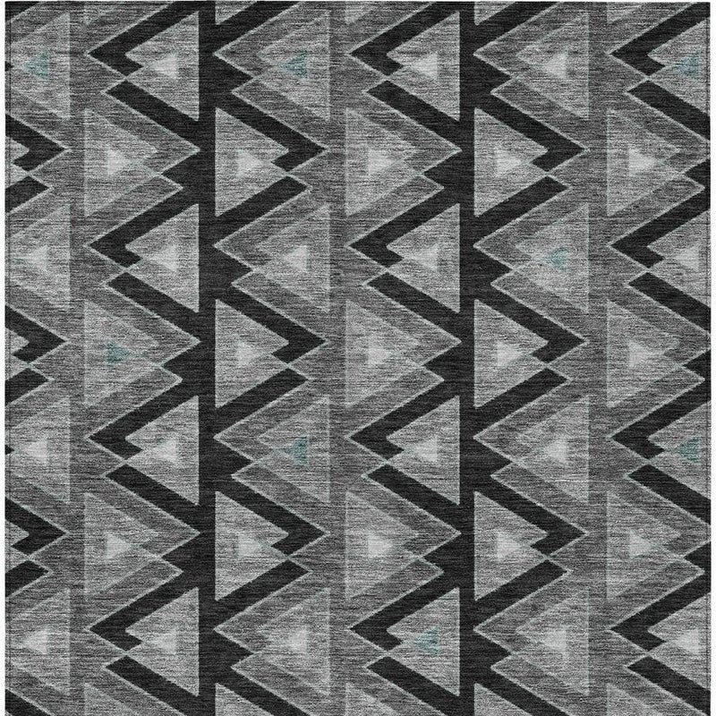 Gray and black geometric zigzag rug pattern with repeating arrow shapes.