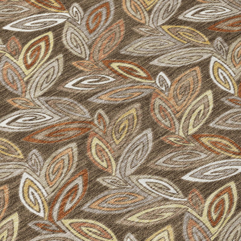 Close-up of leaf botanical print area rug in brown, tan, gray, and muted orange