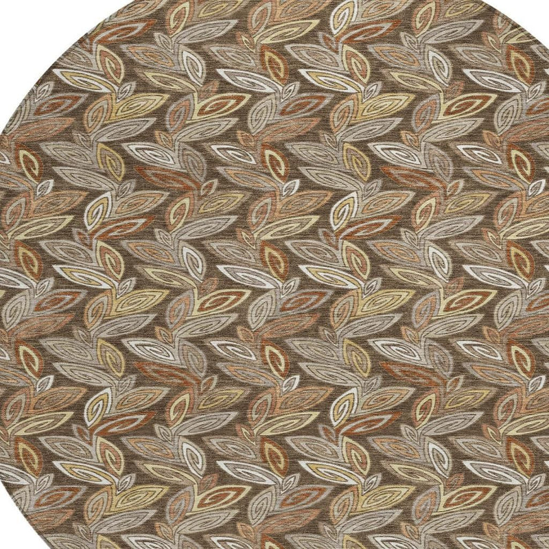 Close-up of round botanical leaf rug pattern in brown, rust, olive, and cream on taupe