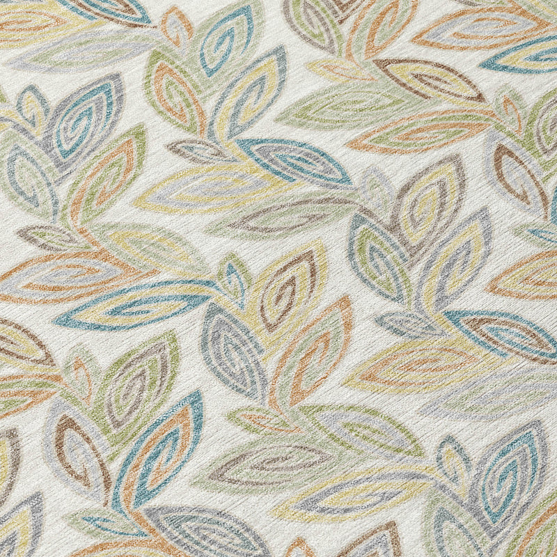 Close-up botanical leaf print on ivory area rug with blue, green, yellow, and orange.