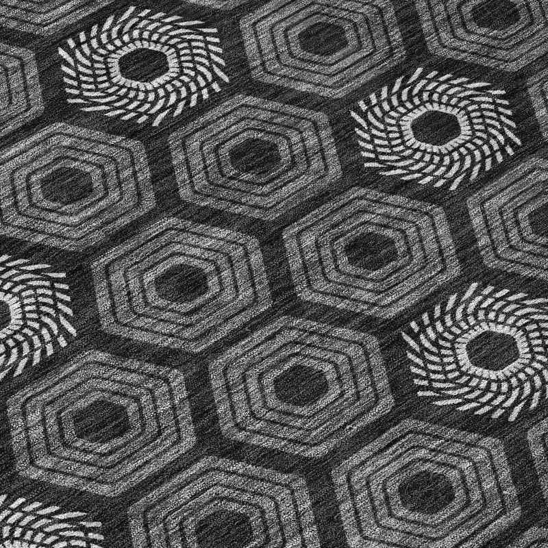 Black and gray patterned area rug with circular rosettes and hexagon block shapes