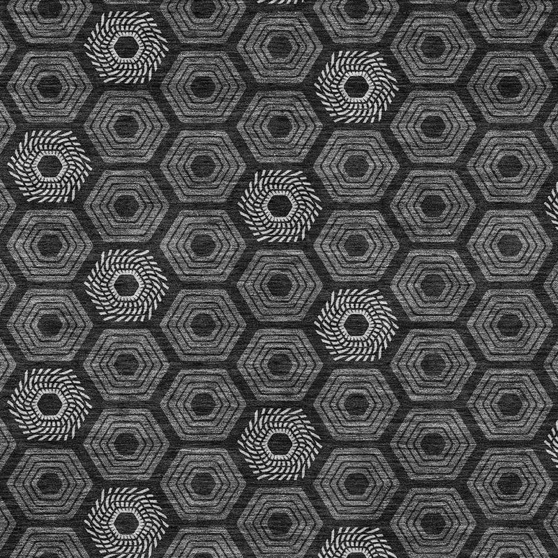 Geometric area rug in black and gray with repeating hexagon and rosette motif
