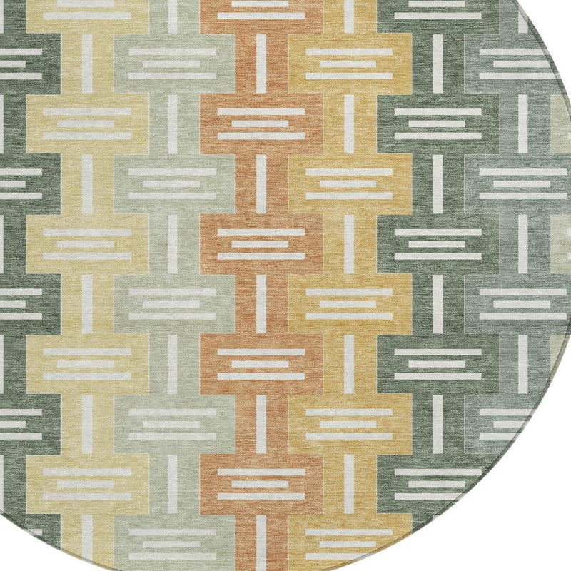 Close-up round area rug showing light and dark green geometric bars with gold