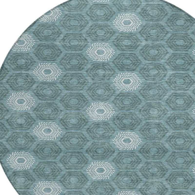 Round teal and ivory geometric area rug featuring rosette medallions and hexagon pattern