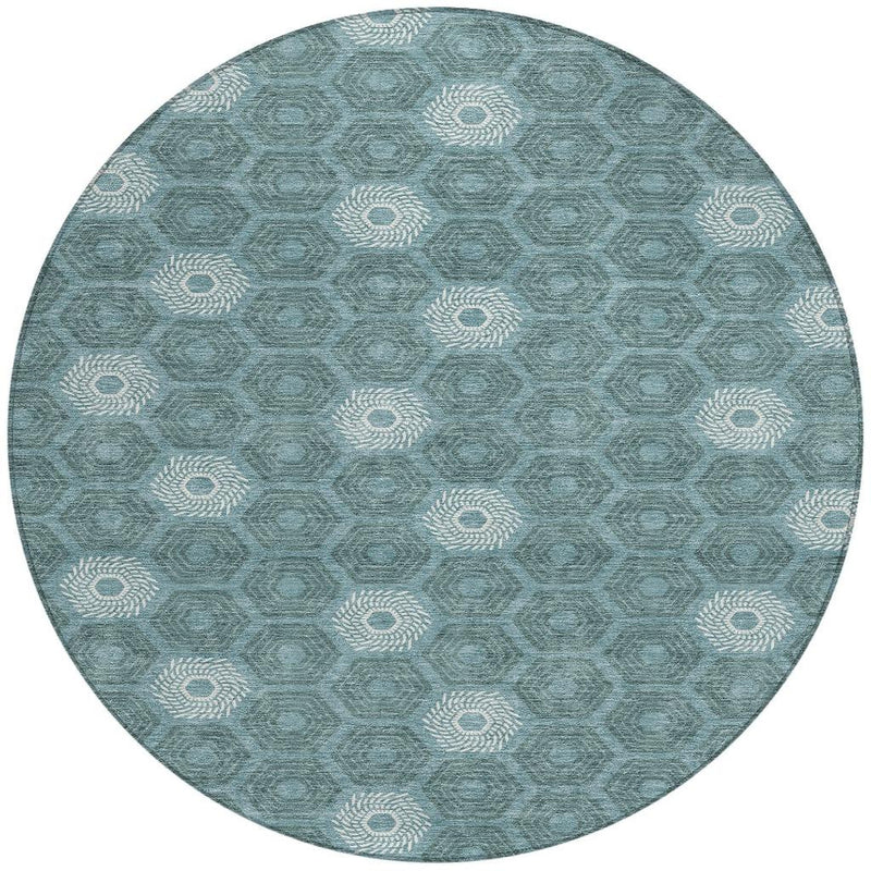 Round teal and ivory geometric area rug with interlocking hexagon shapes and rosettes
