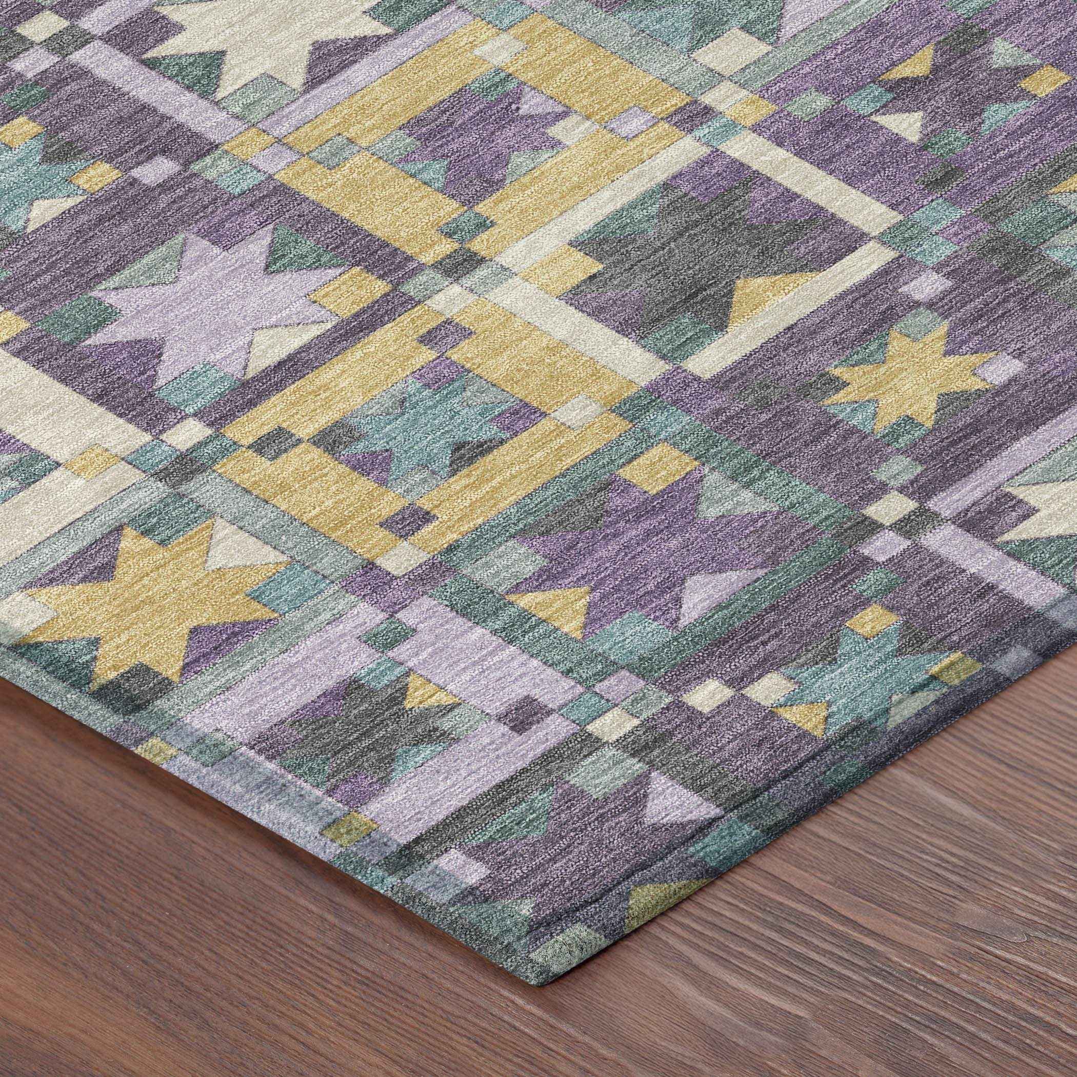 Multicolor geometric area rug in purple, gold, and teal on a wooden floor, featuring intricate star patterns.