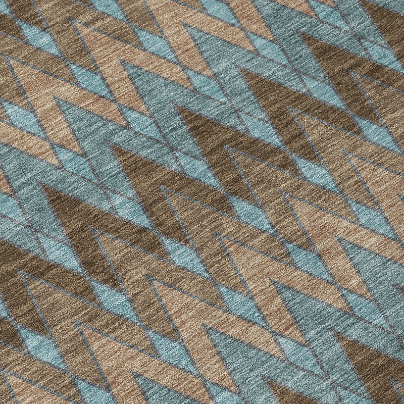 Woven rug close-up with blue-teal chevrons over brown and beige threads