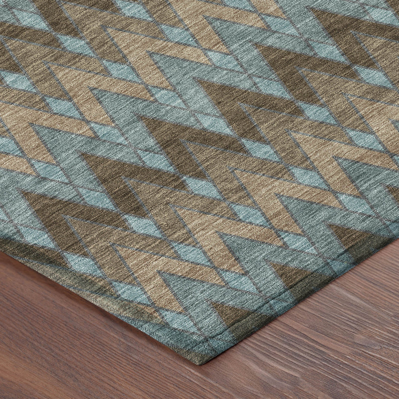 Corner view of round rug with teal, brown, and beige chevron pattern
