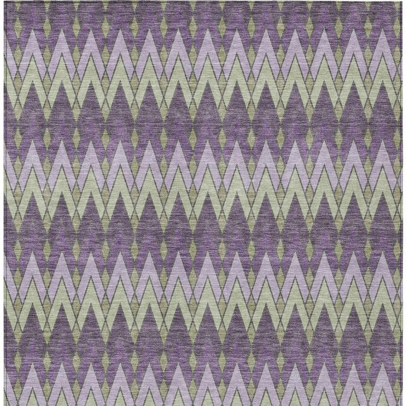 Geometric indoor/outdoor area rug in purple, plum, and light green zigzags