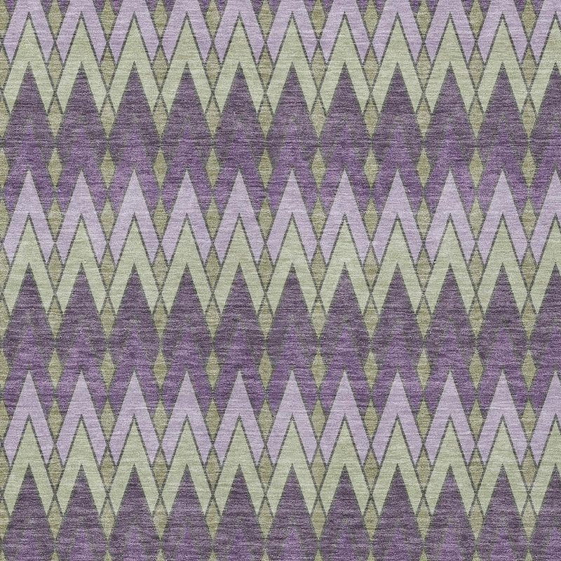 Close-up of purple geometric area rug with repeating zigzag diamond shapes