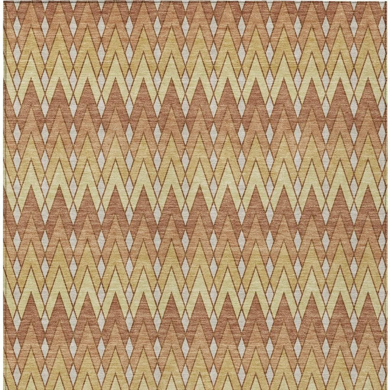 Orange and copper chevron patterned area rug with cream arrow motifs.