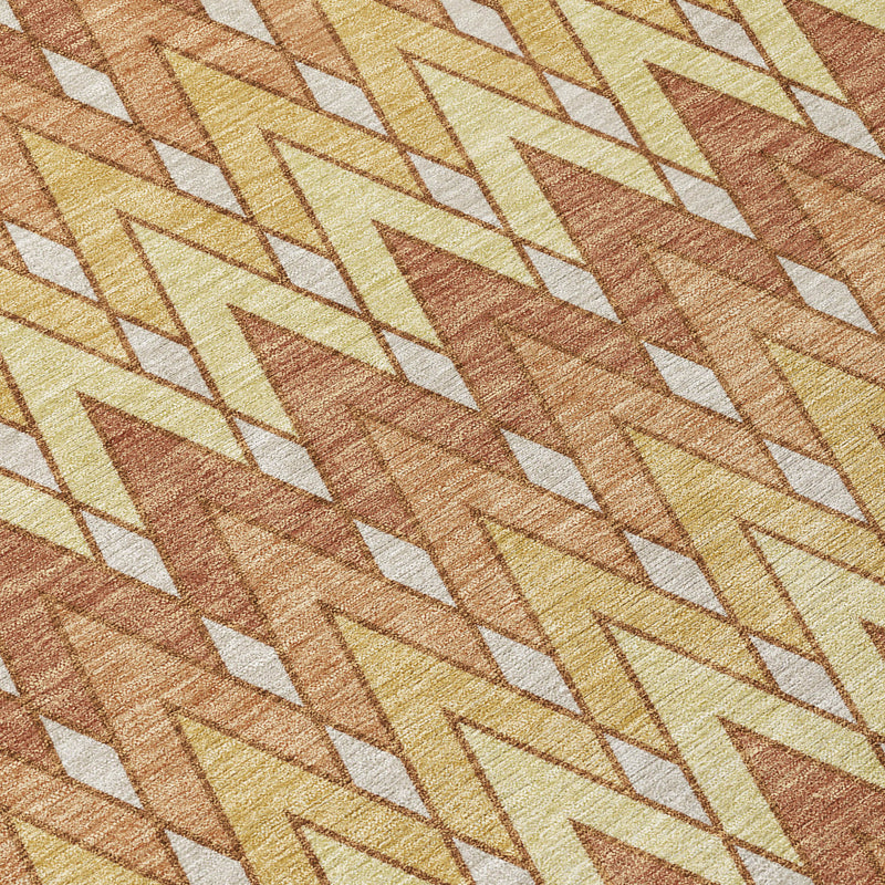 Geometric chevron rug in orange, copper and cream with textured weave detail.