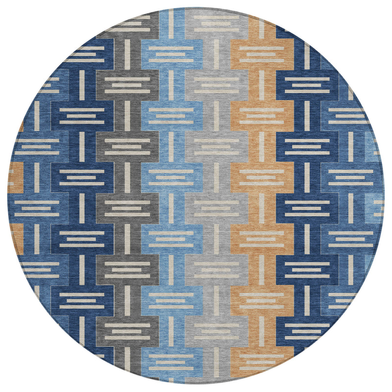 Round washable area rug with geometric pattern in navy, blue, tan, and gray blocks.