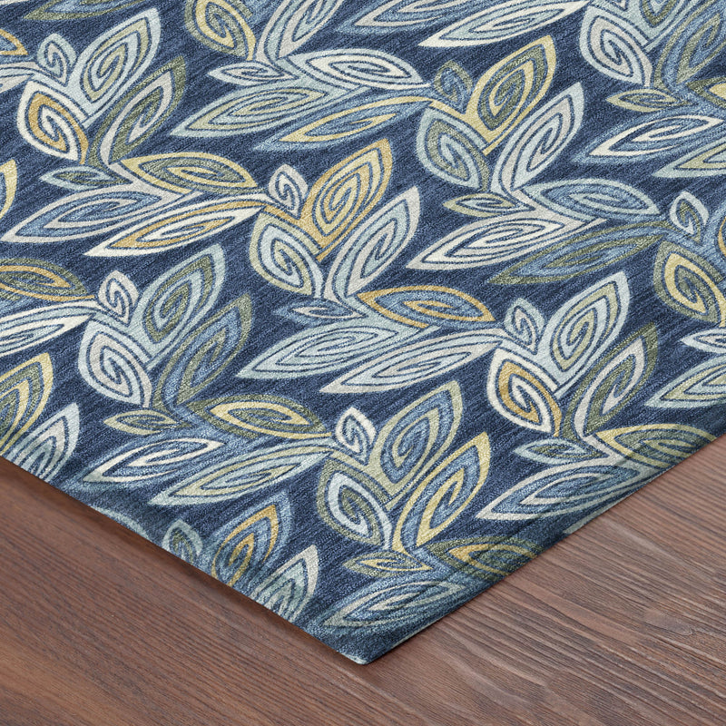 Navy blue rug corner with botanical leaf pattern in light blue and yellow-green