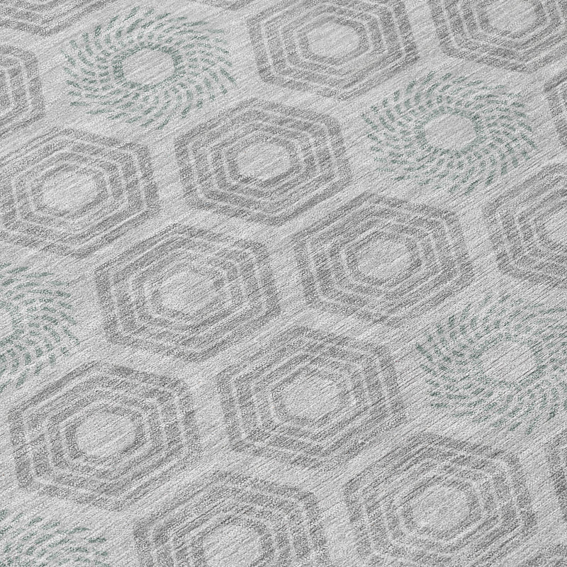 Close-up of silver and granite gray geometric rug with repeating hexagon and octagon motifs