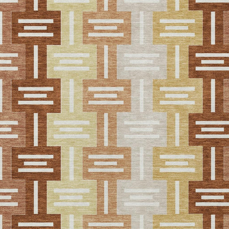 Close-up geometric area rug pattern in brown, copper-orange, cream, and light yellow