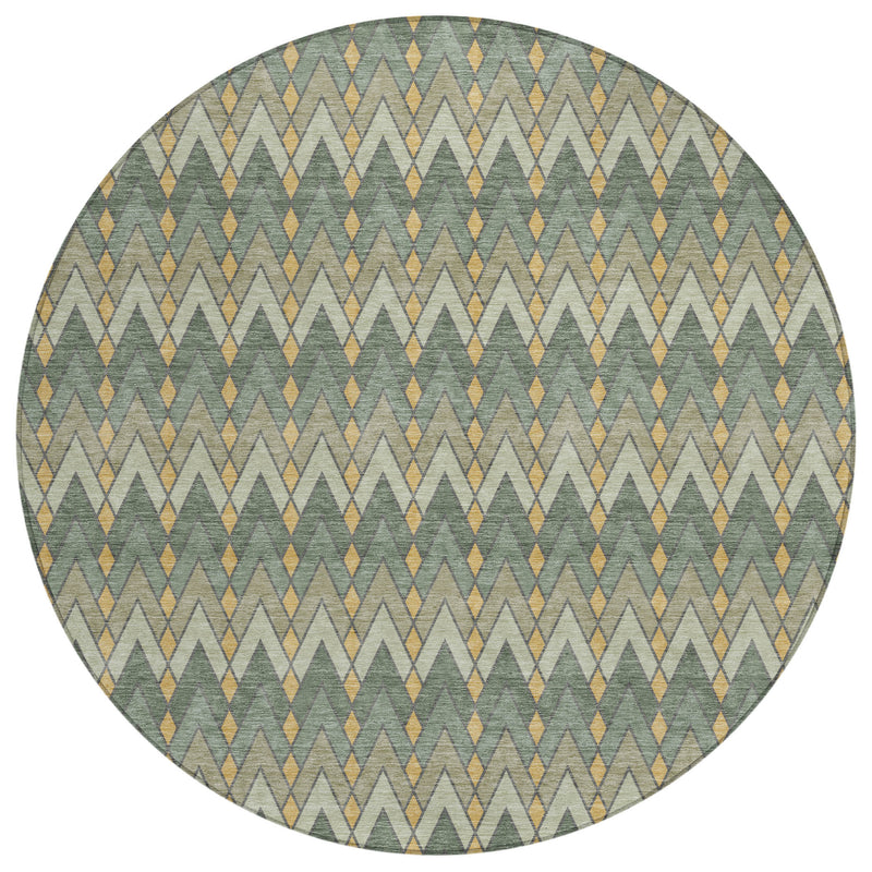 Round geometric area rug with repeating diamond and chevron pattern in green and gold