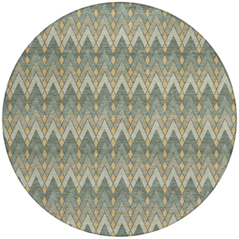 Round geometric area rug in muted greens with gold and tan diamond zigzag pattern
