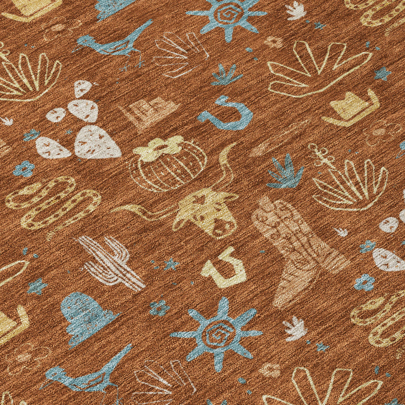 Close-up of orange-brown area rug with blue cactus and desert icons