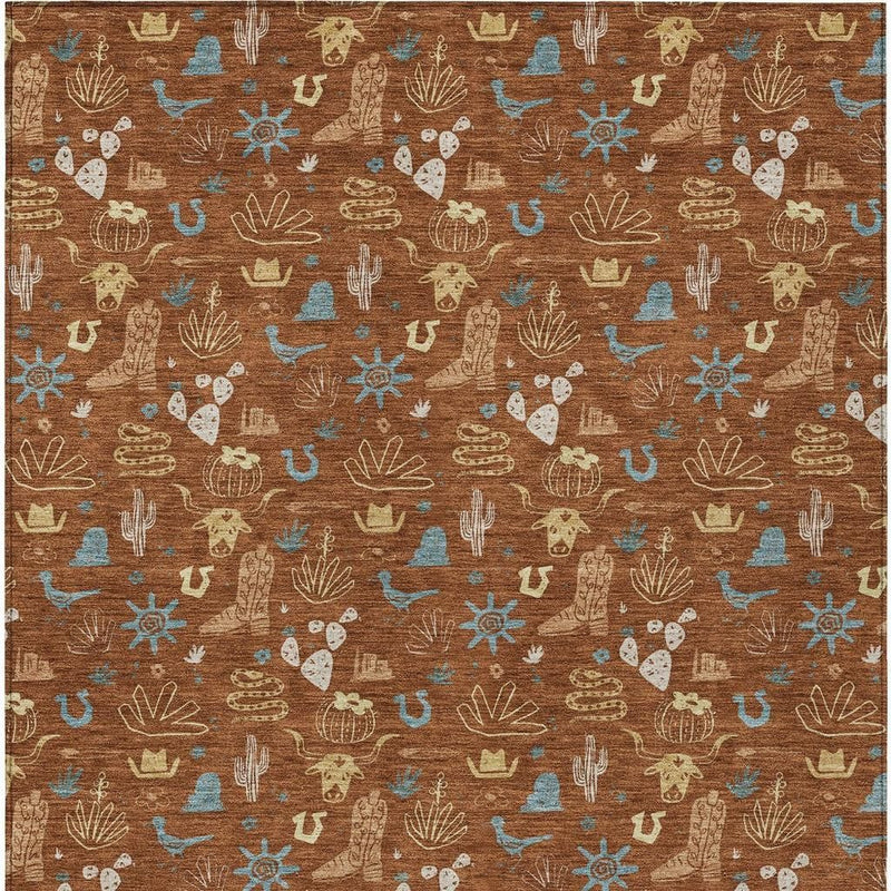Orange-brown indoor outdoor area rug with repeating blue cactus and sunburst icons