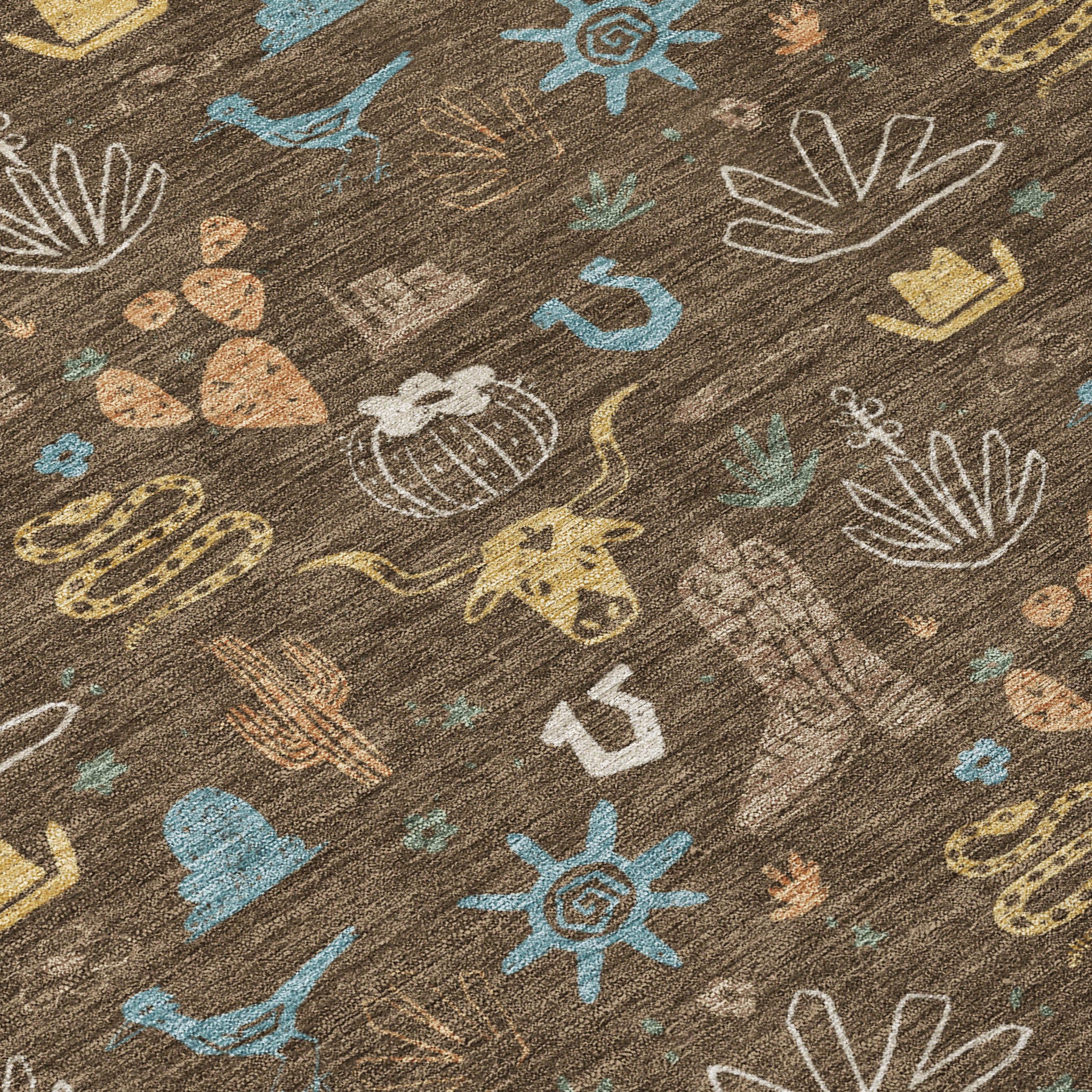 Close-up of brown fabric with cactus and desert icons in teal, tan, white, and yellow