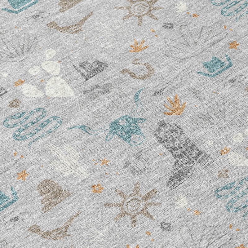 Close-up area rug texture with light gray ground and teal and tan desert icons