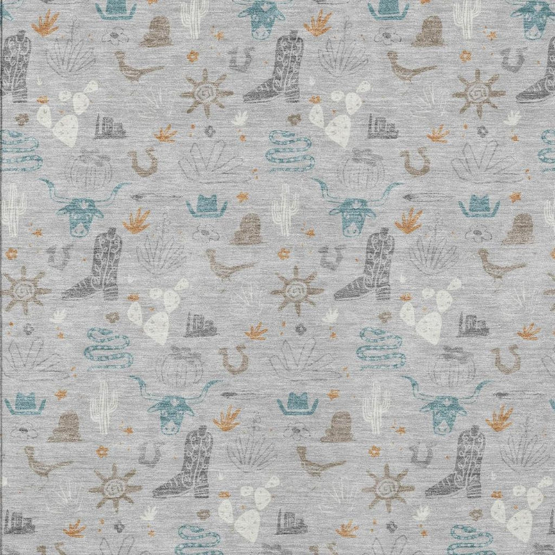 Detailed area rug surface showing light gray fabric and scattered teal and tan motifs