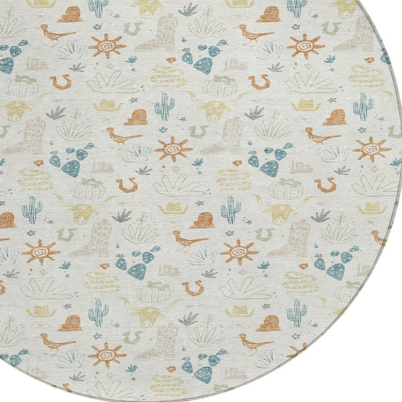 Round area rug edge detail with desert icons in blue, green, and tan on ivory