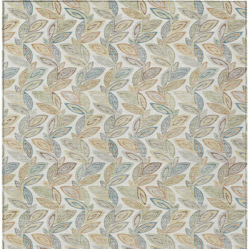 Botanical leaf area rug with scattered leaf motif in blue, tan, green on ivory