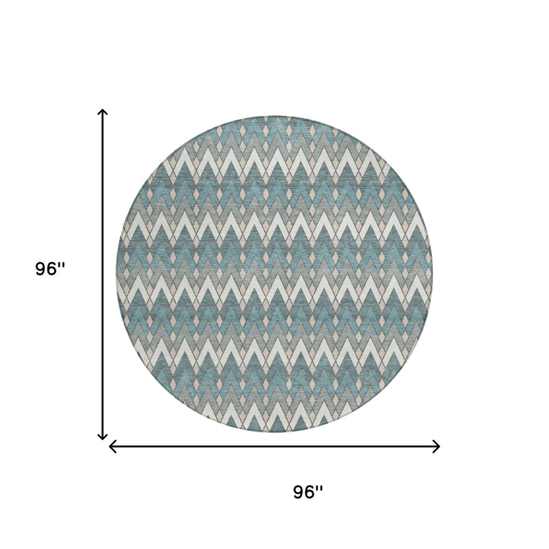 Round teal blue and ivory geometric area rug shown with size measurement on white.