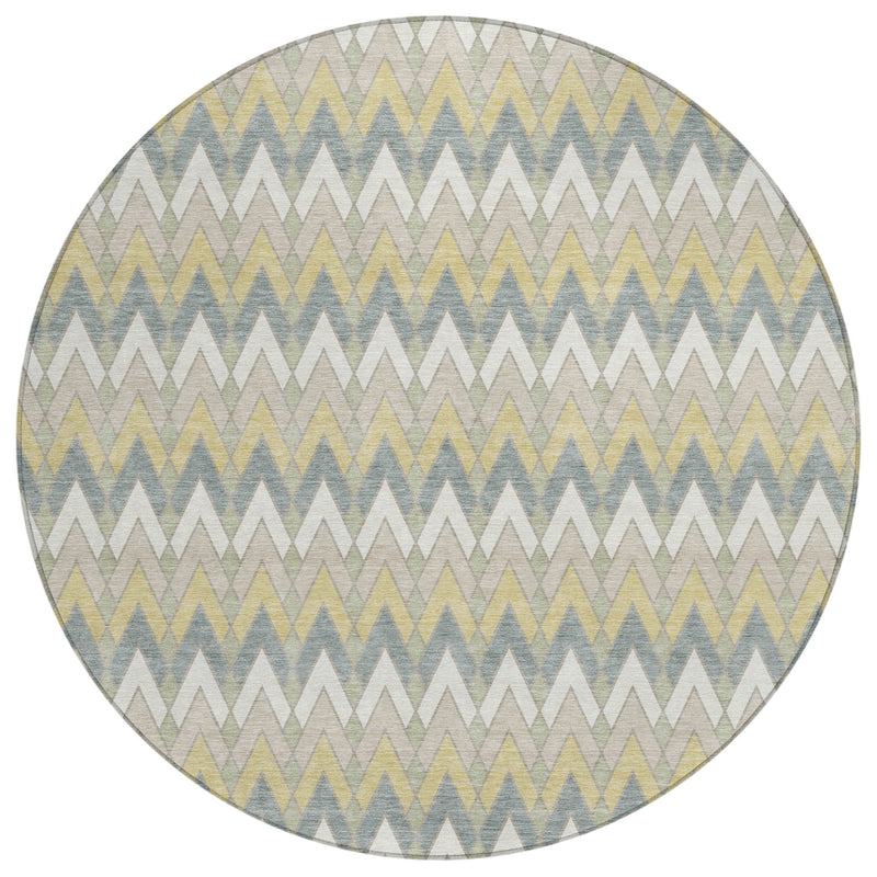 Round geometric area rug in light ivory with blue, green, and yellow zigzag pattern