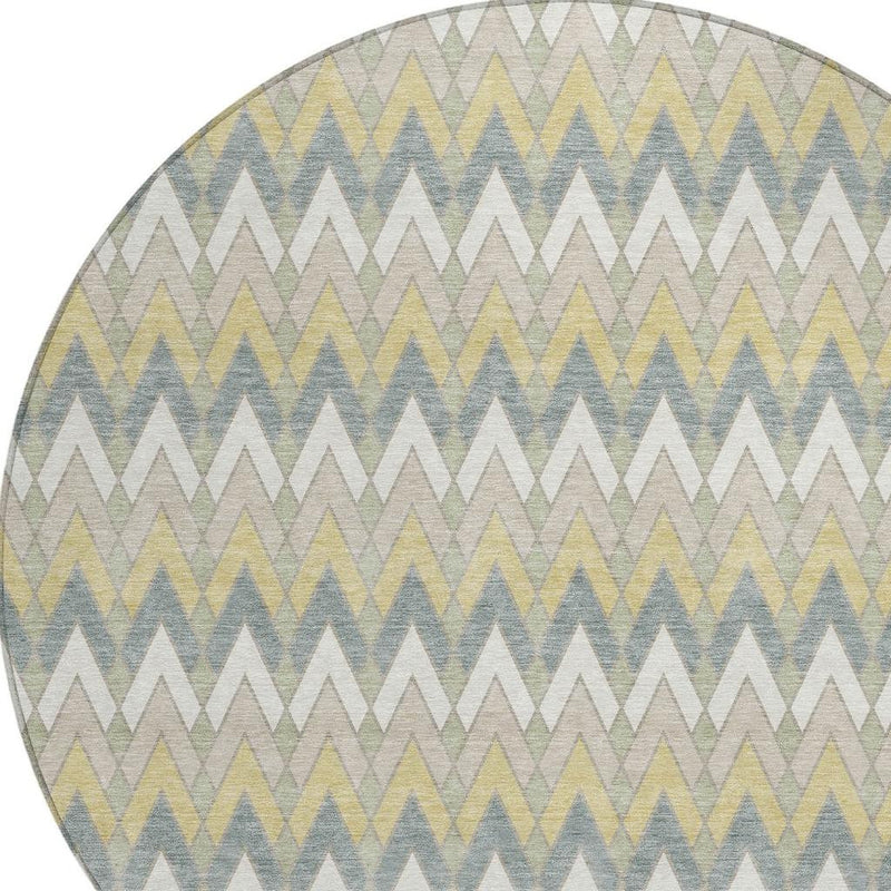 Corner close-up of round rug with zigzag pattern in ivory, blue, green, and soft yellow