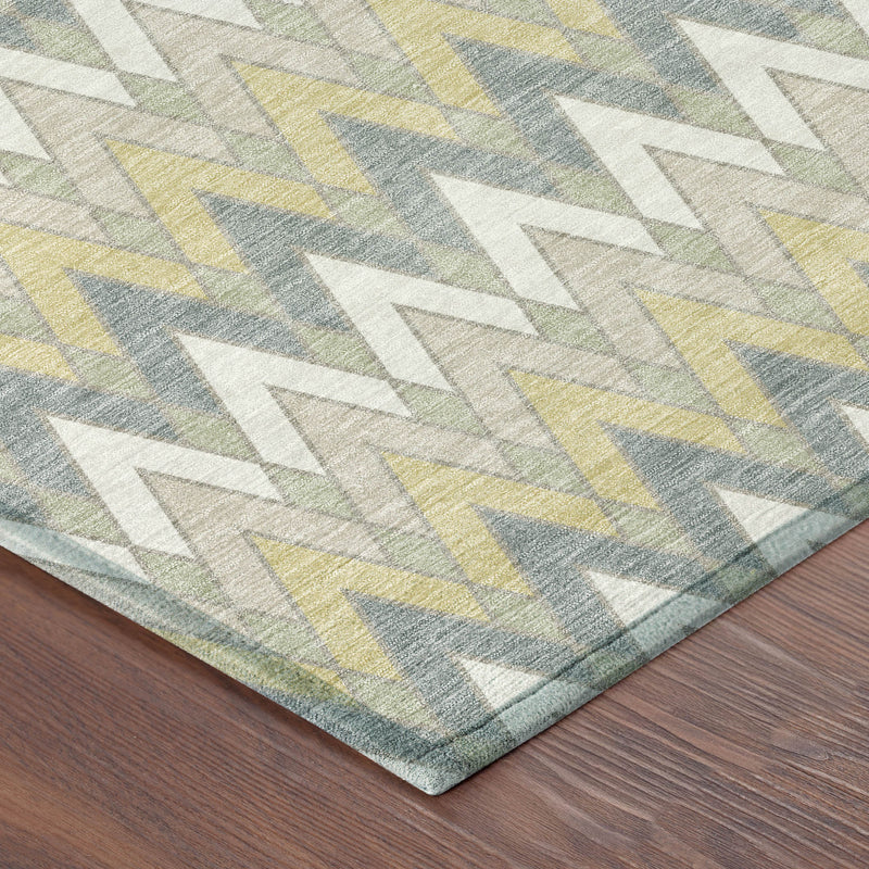 Geometric area rug corner with ivory chevrons and blue, yellow, and green accents