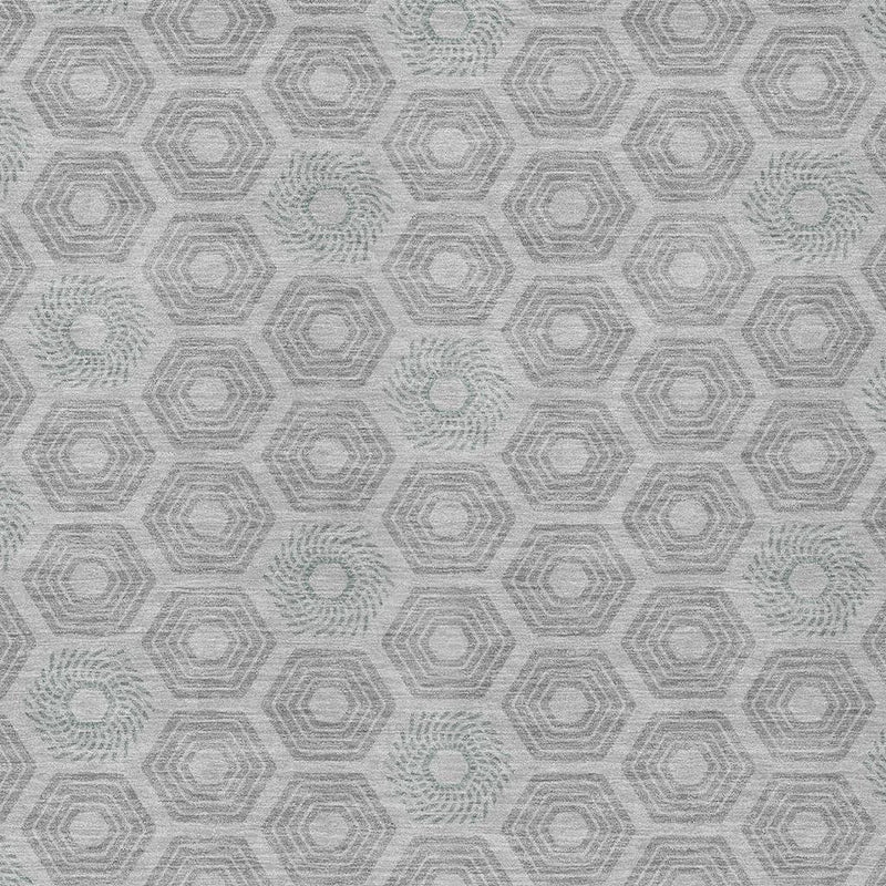 Close-up of silver-gray area rug featuring repeating geometric hexagon motifs
