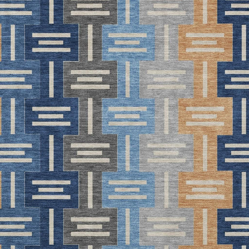 Geometric area rug in navy, light blue, tan, and gray with rectangular bar motif.