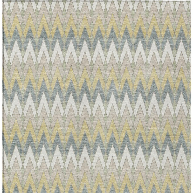 Ivory area rug with geometric chevron pattern in blue, green, and beige