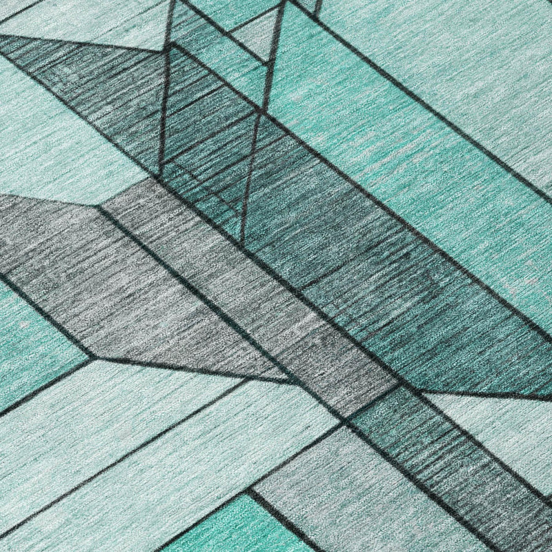 Geometric rug edge with aqua top stripe and dark gray border along diagonal panels