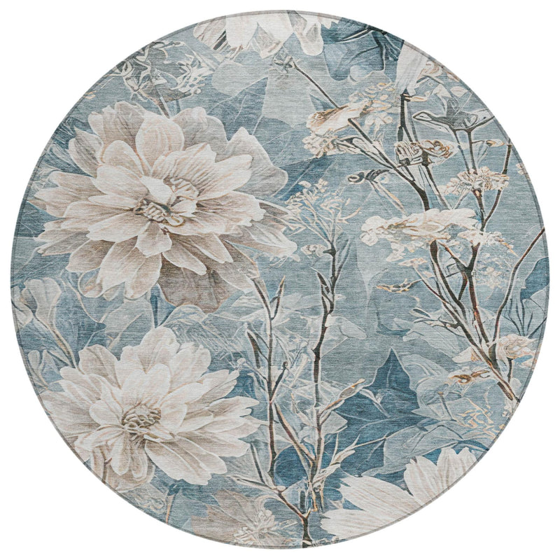 Round floral area rug in teal blue with cream blossoms and silver details